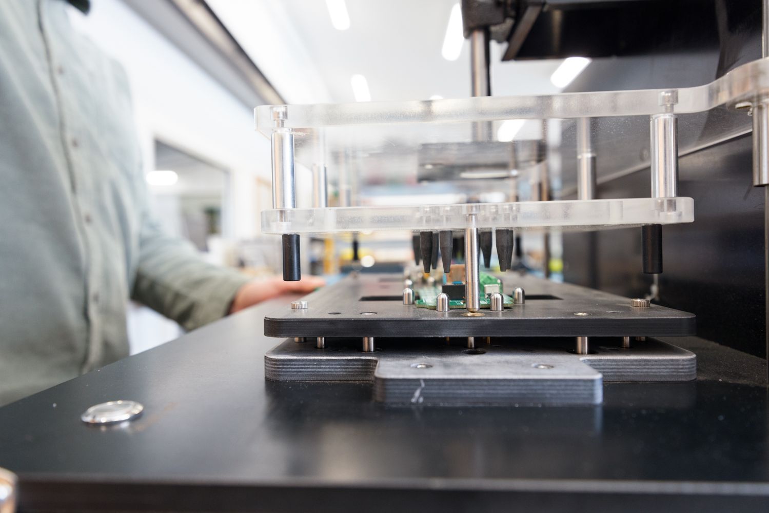 Test jig probing a populated circuit board